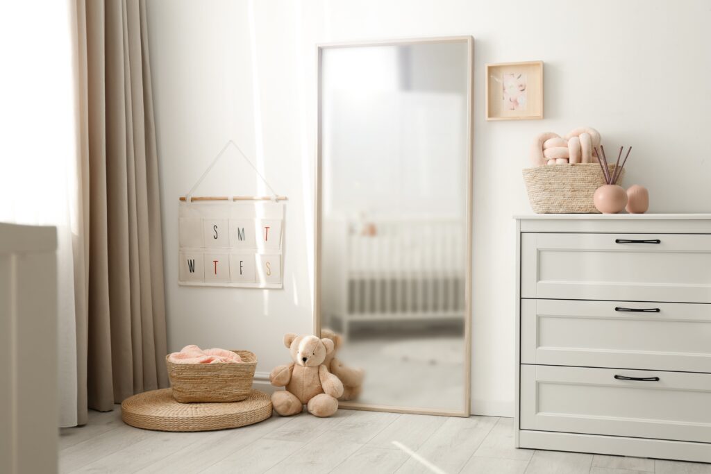Beautiful nursery interior with white chest of drawers